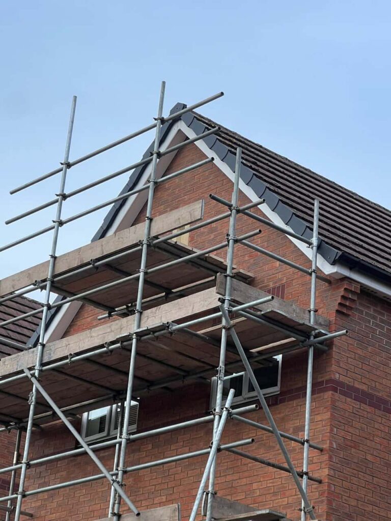 This is a photo of a roof which has just been repaired. There is a scaffold located at the gable end for access onto the roof. Works carried out by Westerham Roofing Repairs
